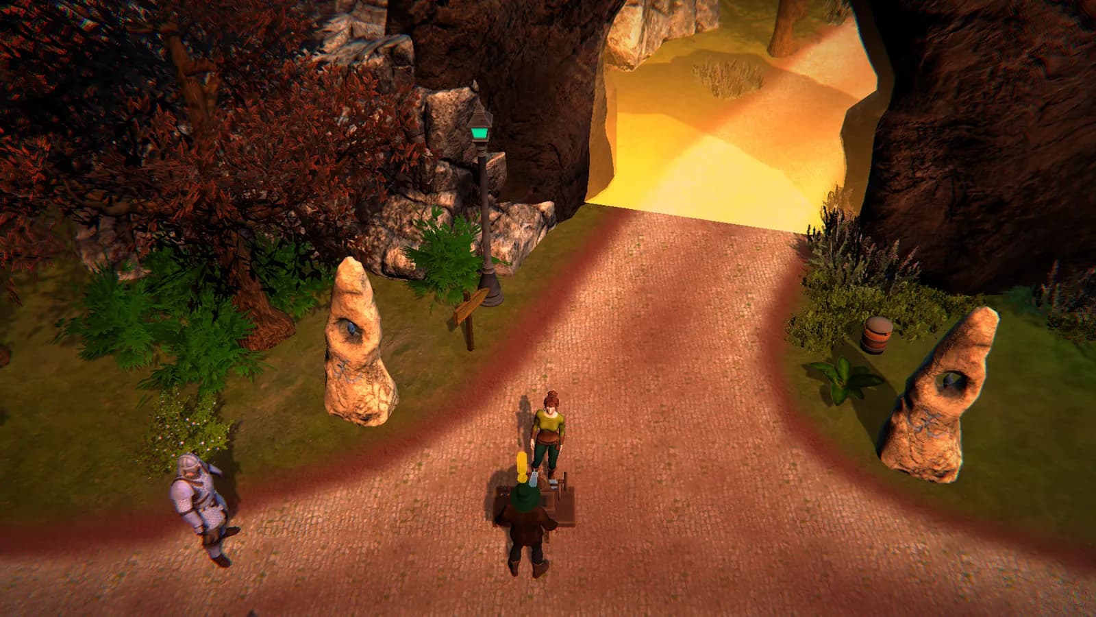 A cobbled road leads to a cave mouth full of warm yellow light. Two standing stones with holes in them, a lamp post with a green lantern and a signpost line the road. A character in armour stands at the left edge, and two more characters stand near a small wooden table at the centre.